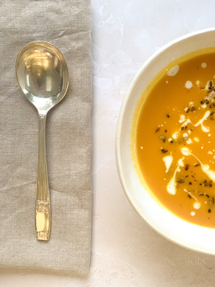 Bowl of Carrot Orange Soup with spoon